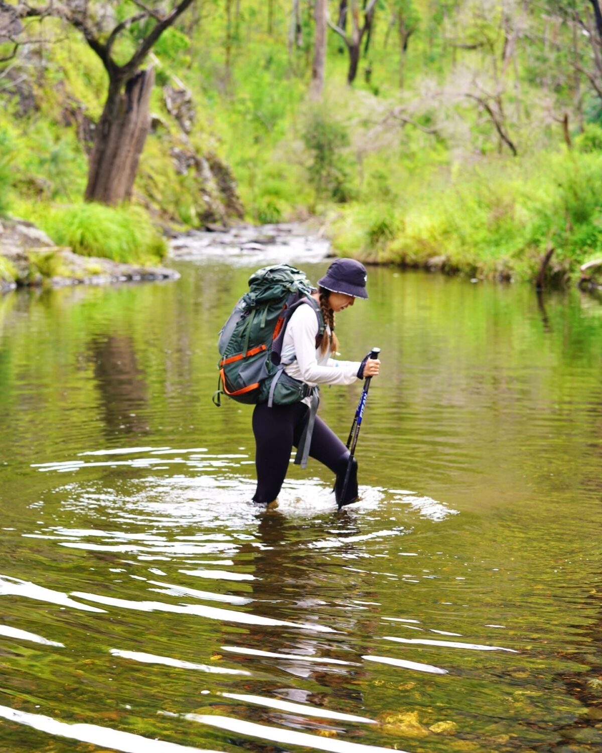 Woman crossing river, Green Gully track, Oxley Wild Rivers National Park. Photo credit: Sue Kang / DPE
