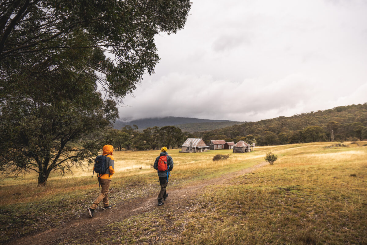Two people walking in Kosciuszko National Park. Photo credit: Rob Mulally / DPE