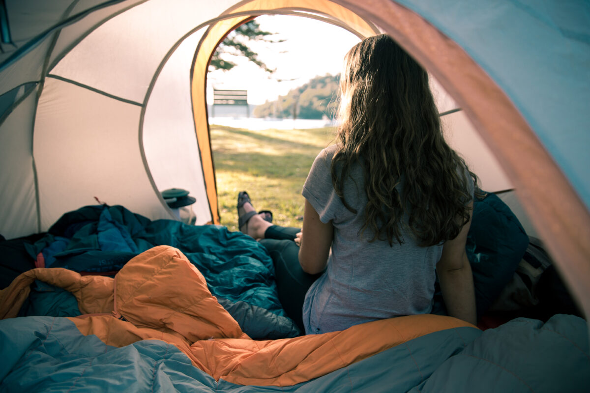 Woman inside tent. Photo credit: Tim Clark / DPE