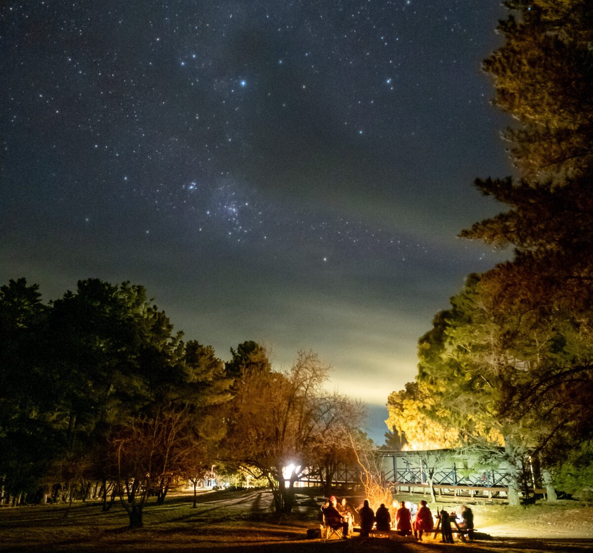People sitting around a campfire at night in Hill End Historic Site. Photo credit: Craig Murphy / DPE