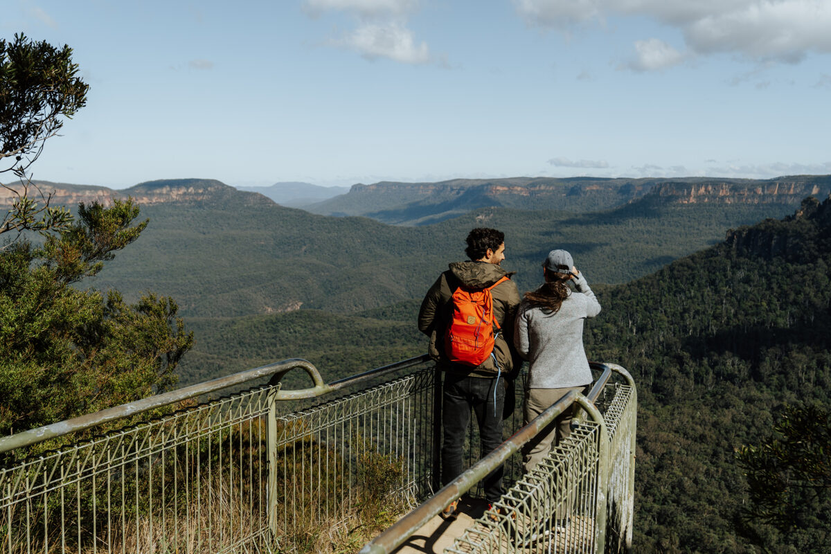 Two people at Golf link lookout, Grand Cliff Top Walk. Photo Credit: Remy Brand / DCCEEW