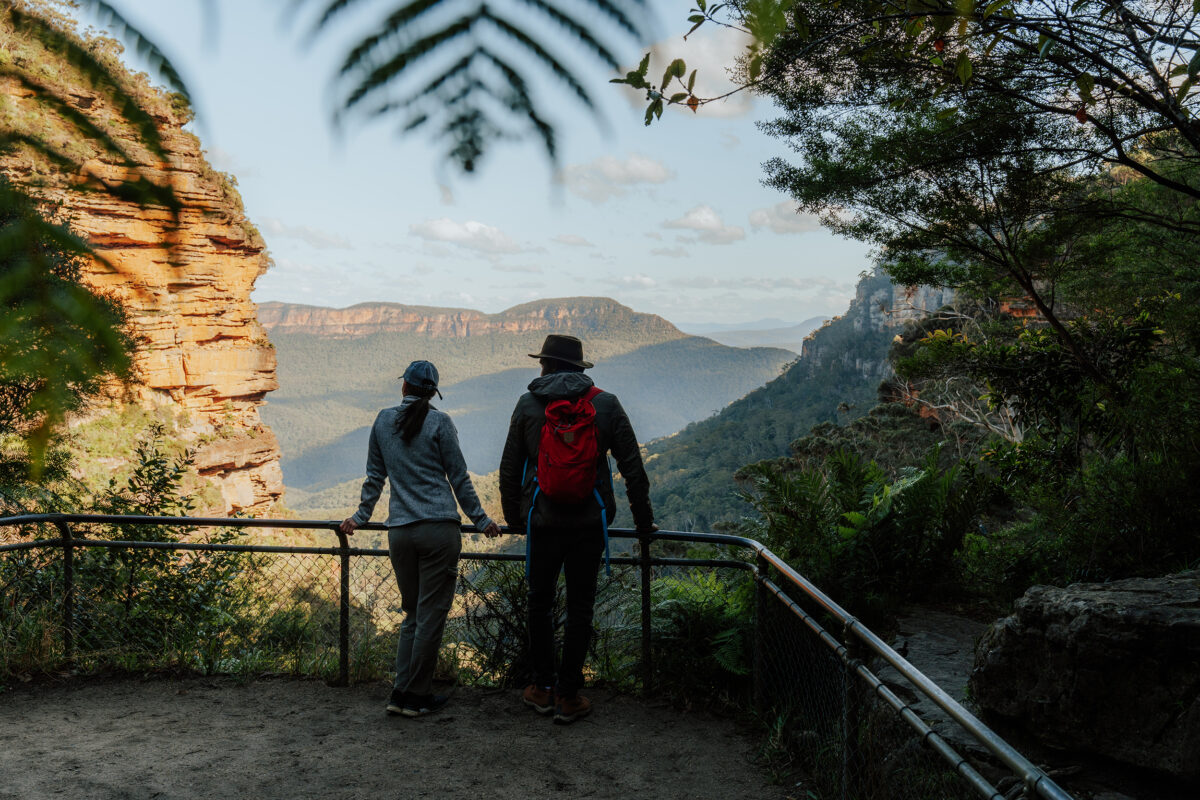 Two people at Leura Falls Lookout, Grand Cliff Top Walk, Blue Mountains National Park, Photo Credit; Remy Brand / DCCEEW