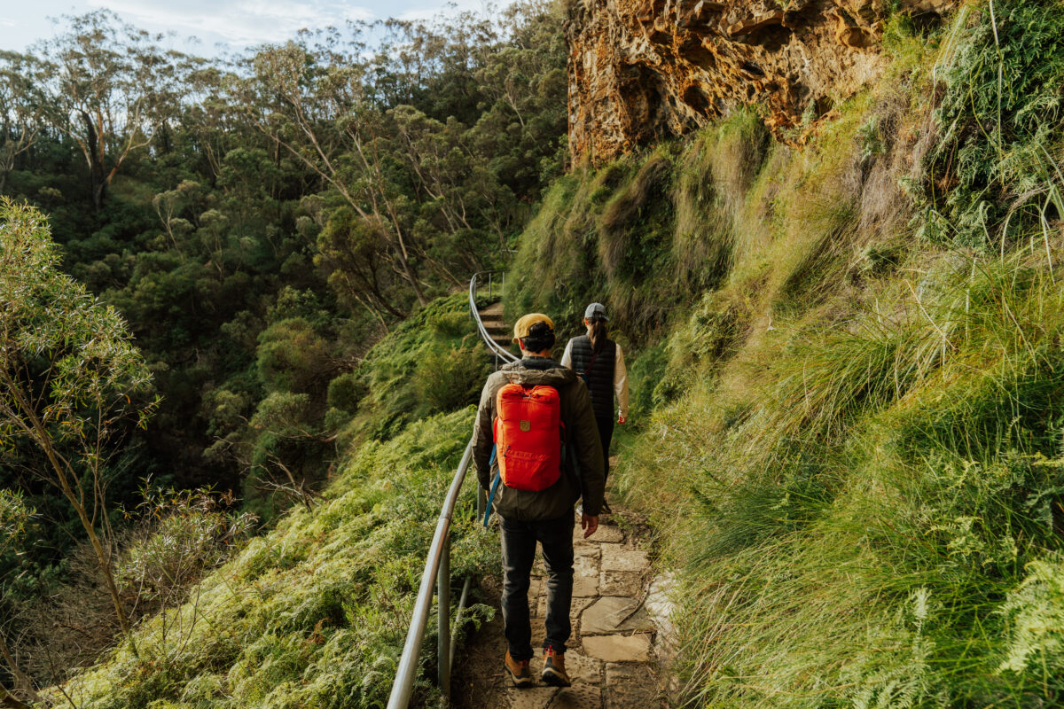 Two people walking on the Overcliff-Undercliff track, Grand Cliff Top Walk, Blue Mountains National Park. Photo: Remy
