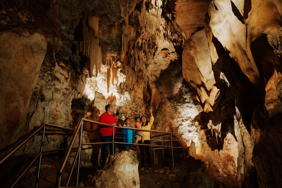 A family of four in Wollondilly Caves, Wombeyan Caves. Photo Credit: Remy Brand / DCCEEW