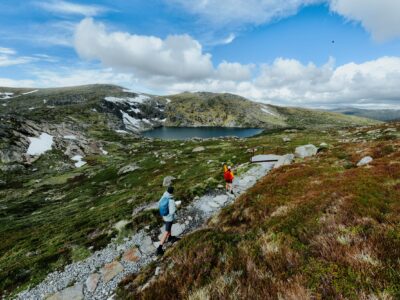 Two walkers take in the veiw from Blue Lake lookout on the Snowies Alpine Walk. Photo credit: Daniel Parsons/DCCEEW