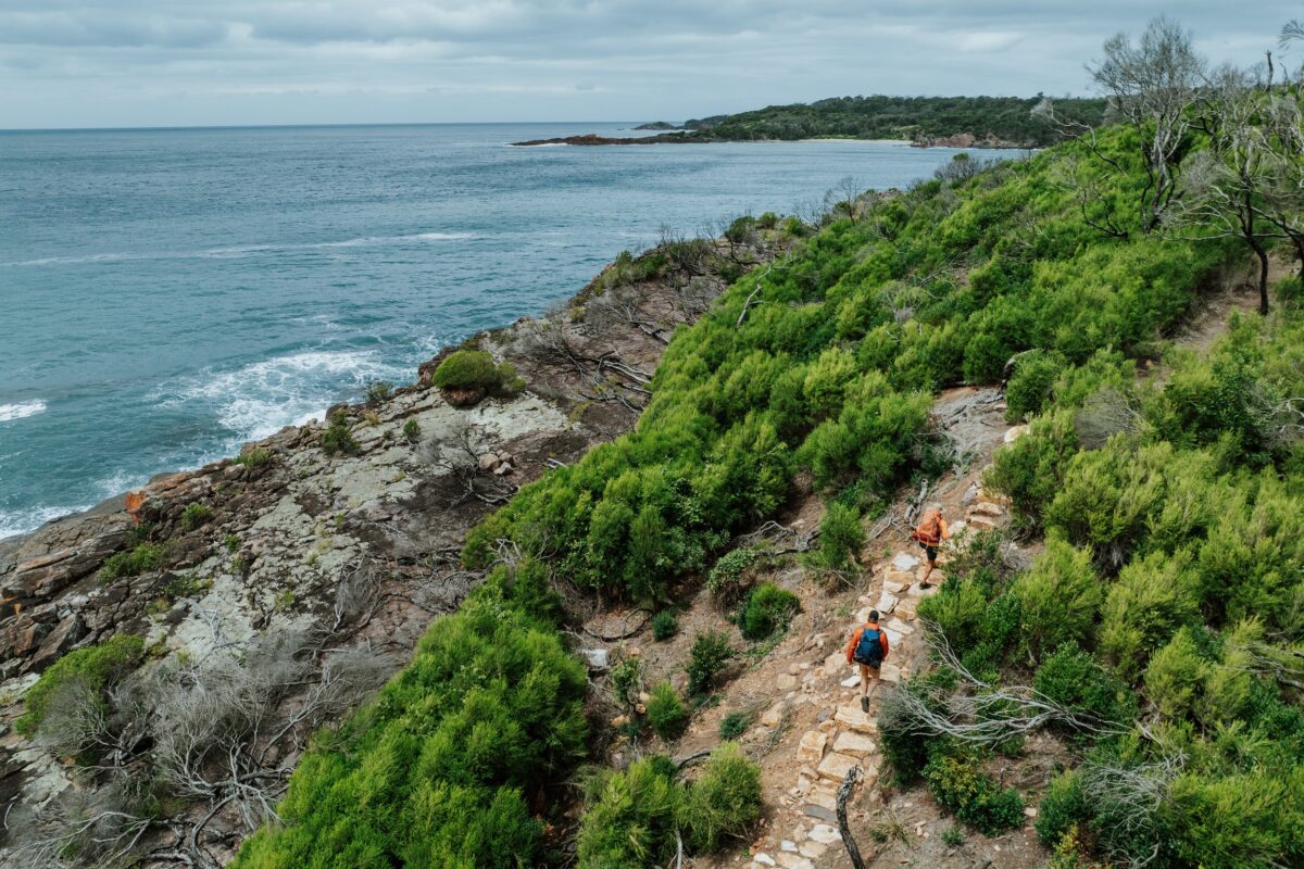 Two walkers at Bobs Rock on the Light to Light Walk. Photo Credit: Daniel Parsons/DCCEEW