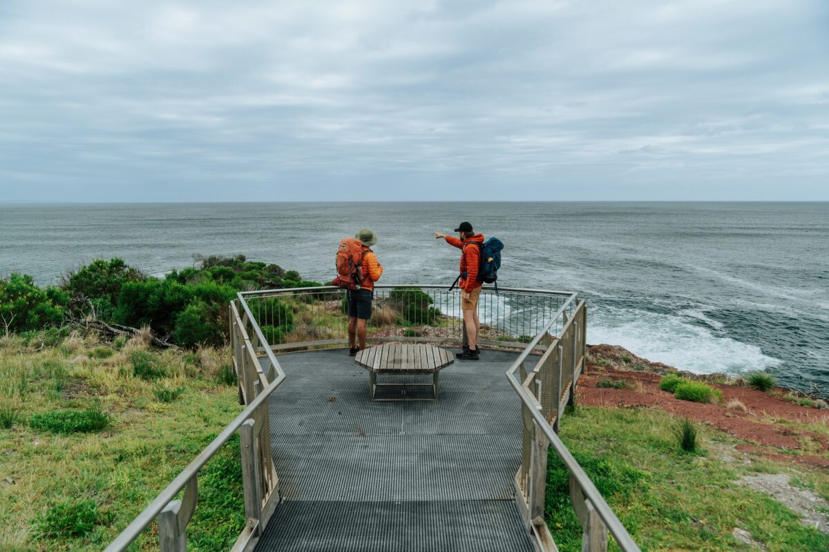 Two walkers check out the view from the lookout at Boyds Tower on the Light to Light Walk. Photo credit: Remy Brand/DCCEEW