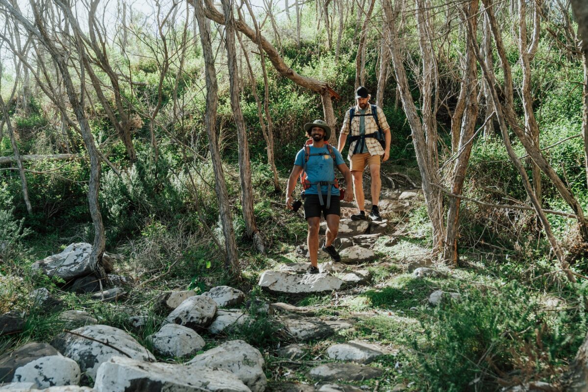 Two walkers at Hegartys Bay on the Light to Light Walk. Photo credit: Remy Brand/DCCEEW