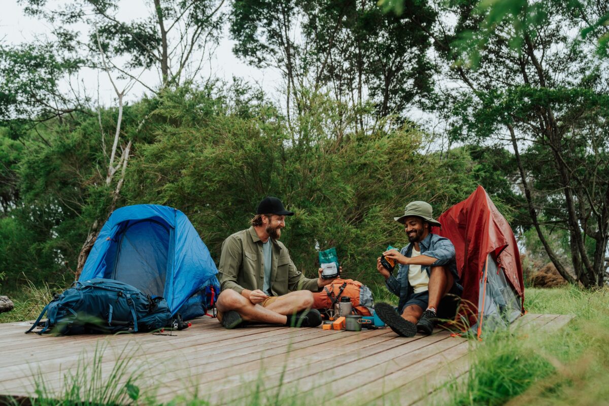 Walkers set up camp on a wooden platform at Mowarry Campground on the Light to Light Walk. Photo credit: Remy Brand/DCCEEW