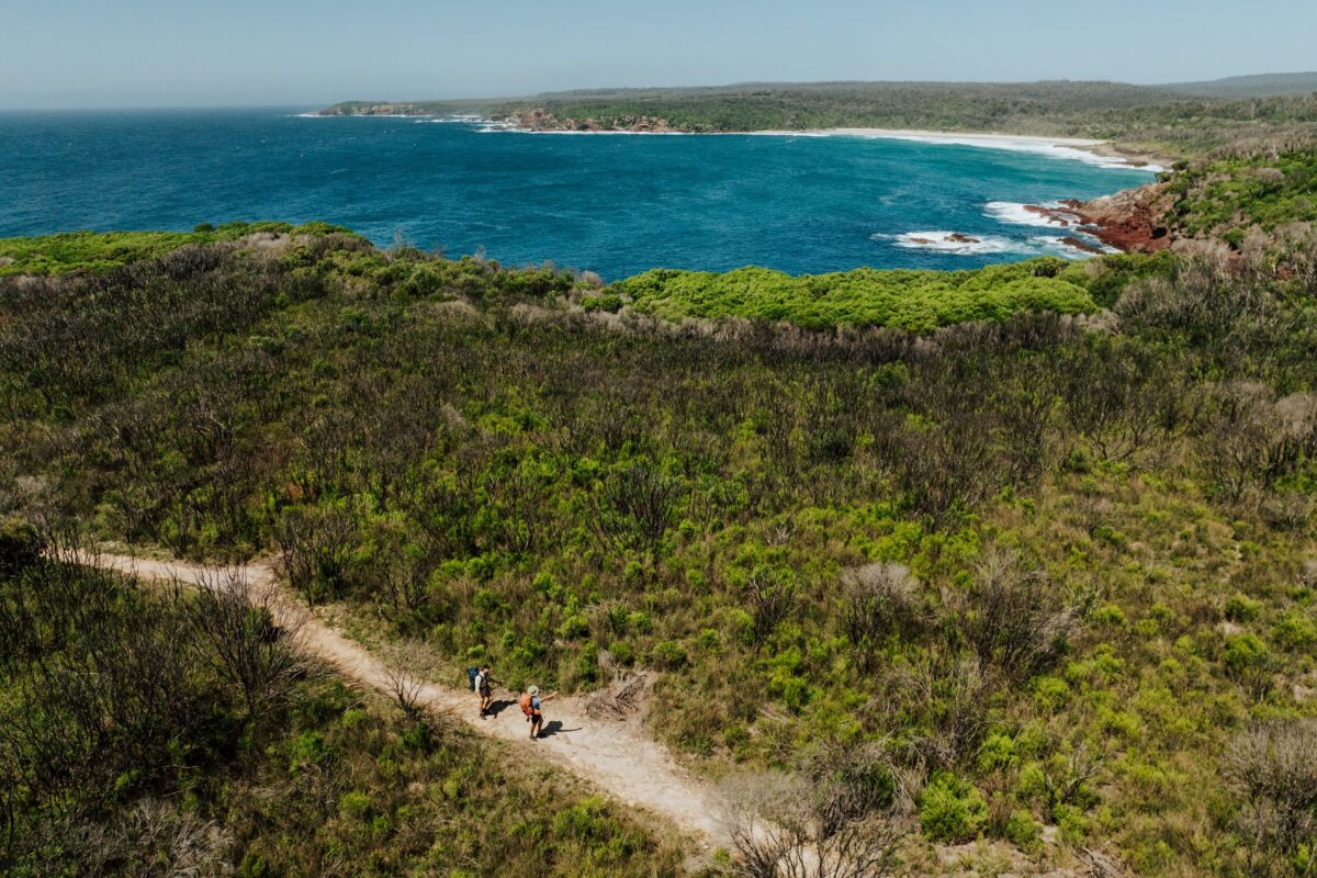 Two walkers at Saltwater Creek on the Light to Light Walk. Photo credit: Daniel Parsons/DCCEEW