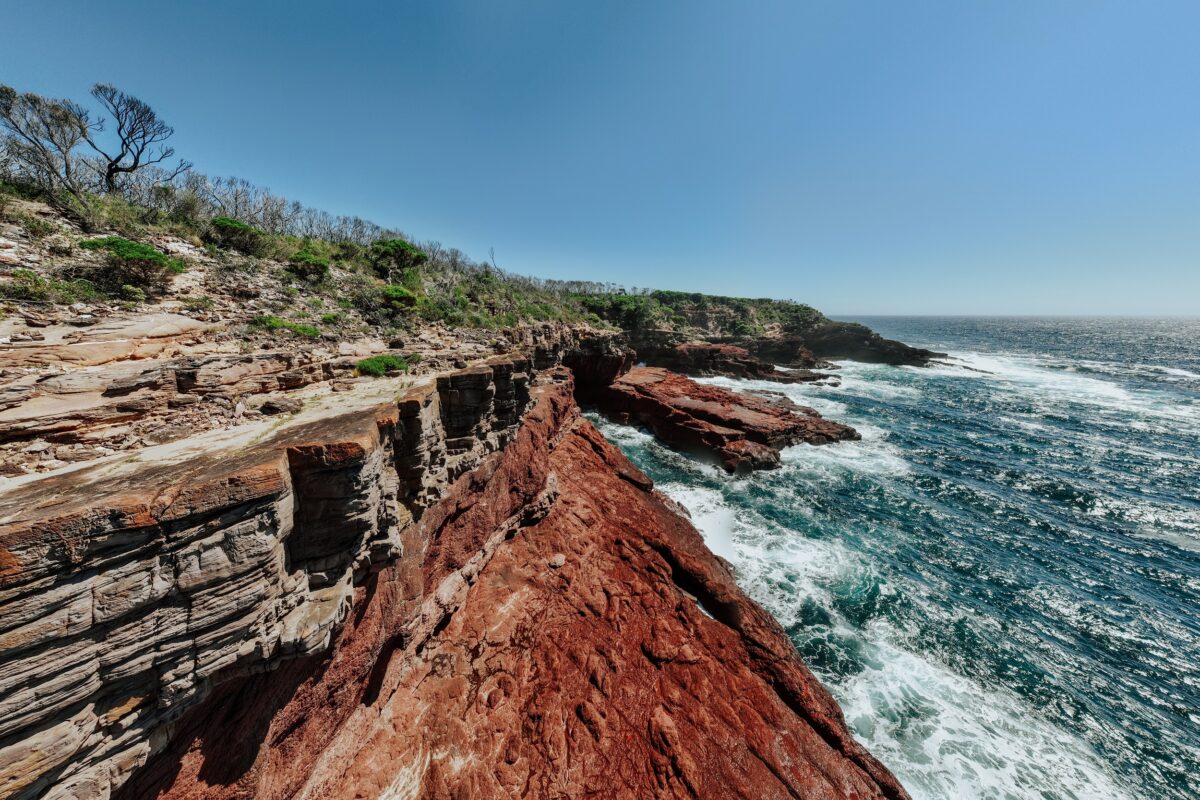 Red rock cliffs along the Light to Light walk. Photo credit: Daniel Parsons/DCCEEW