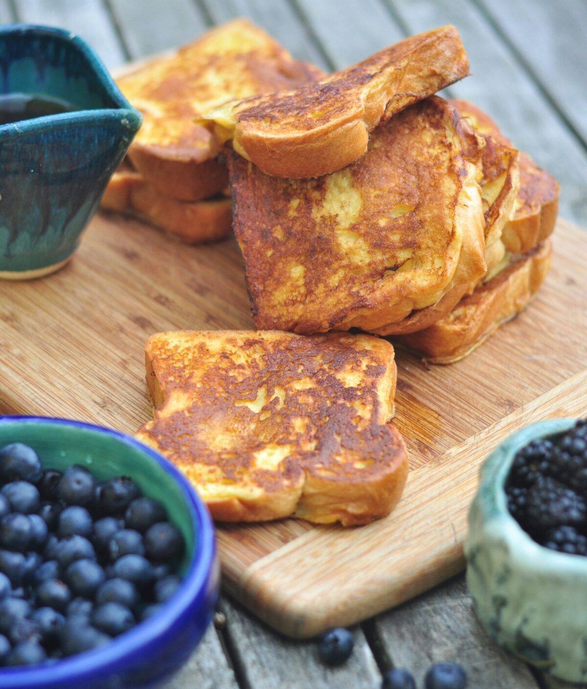 A stack of french toast on a bread board. Photo: I Do Nothing But Love via Unsplash