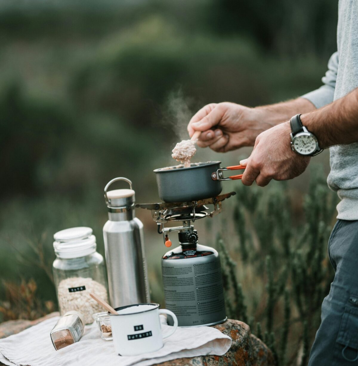 Camper preparing oats on a gas burner. Photo: Taryn Elliott via Pexels