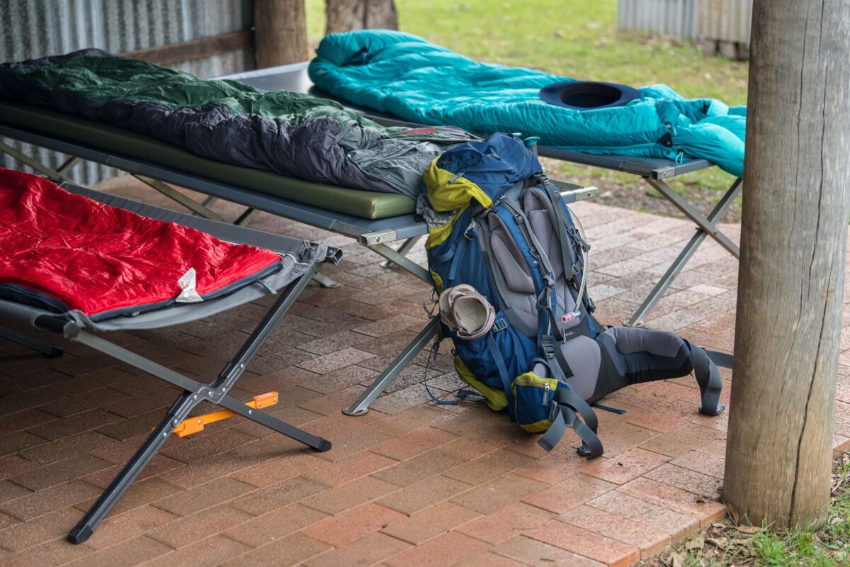 Camping beds set up at a heritage hut on Green Gully Track.