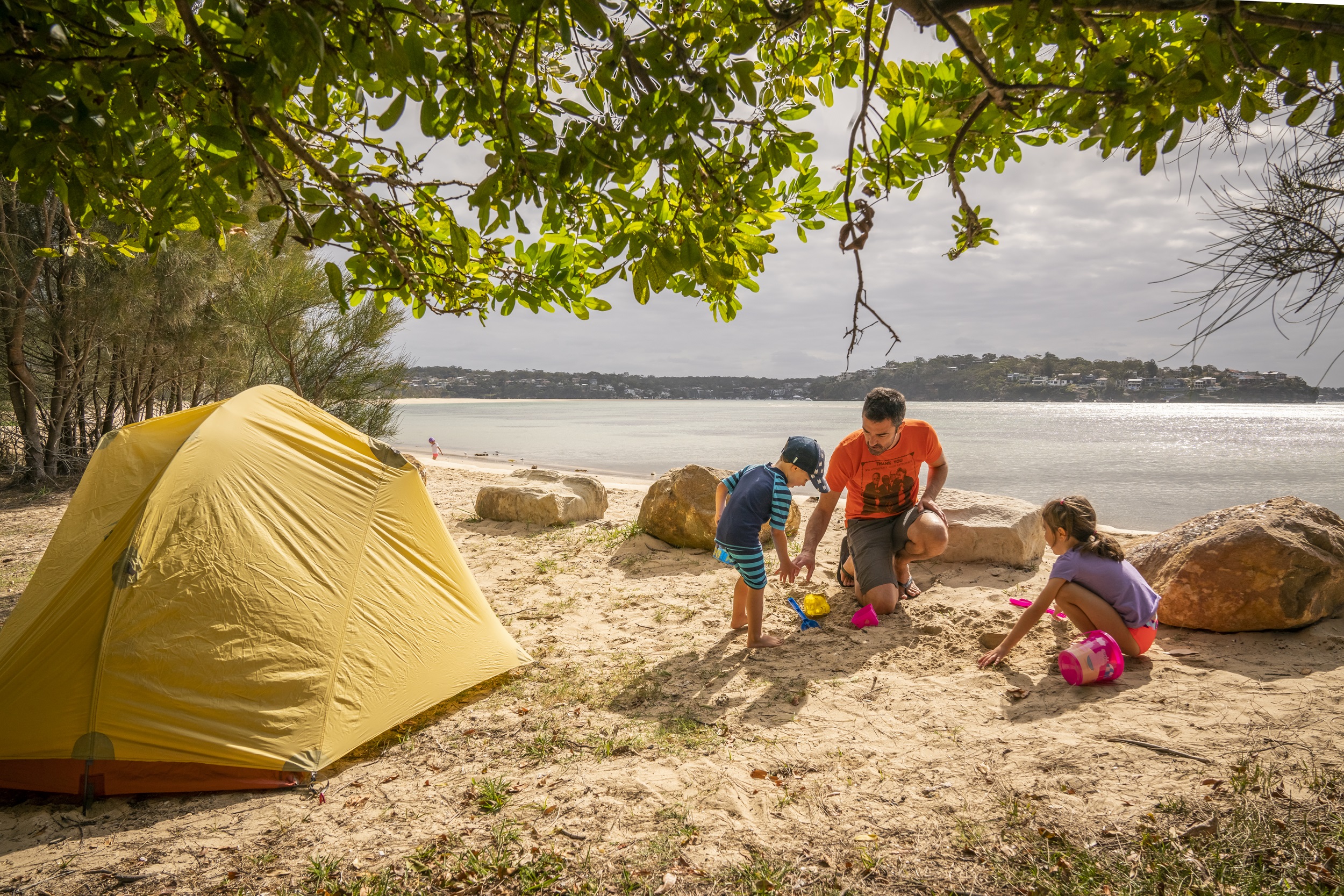 A family camping on the beach at Bonnie Vale campground.